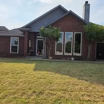 Brick home with newly installed replacement windows on front facade