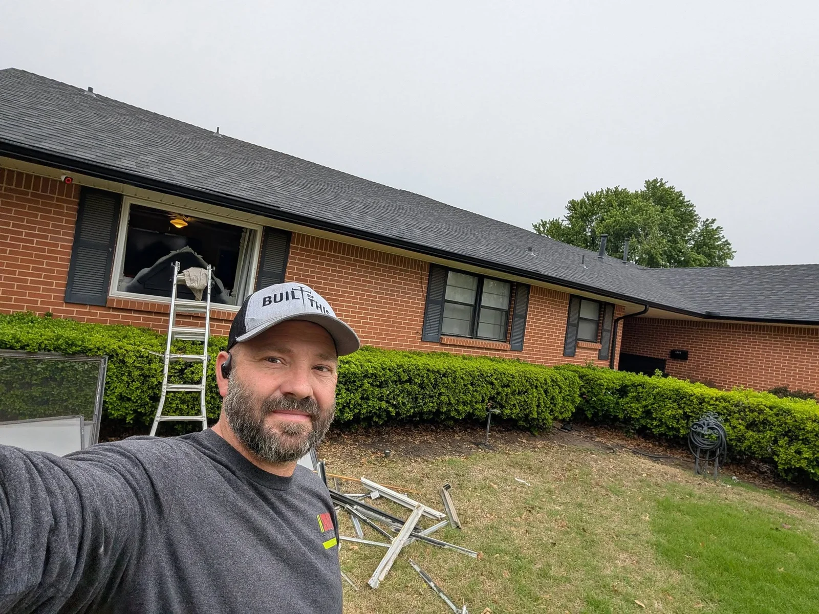 New dark-framed windows installed on brick residential home exterior